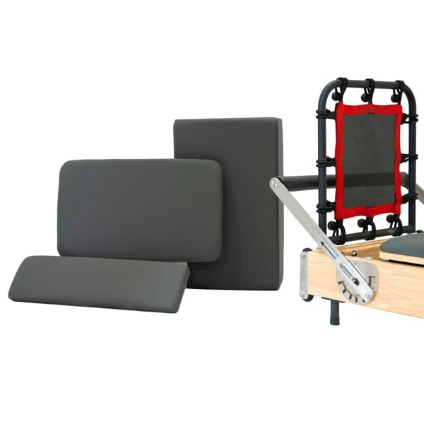 Oak Pilates reformer machine with gray padded cushions, adjustable straps, and a sturdy frame for versatile workouts