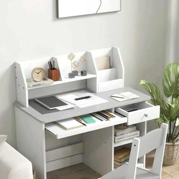 Kids desk with open cubbies, pencil tray, books, and drawer, white desktop