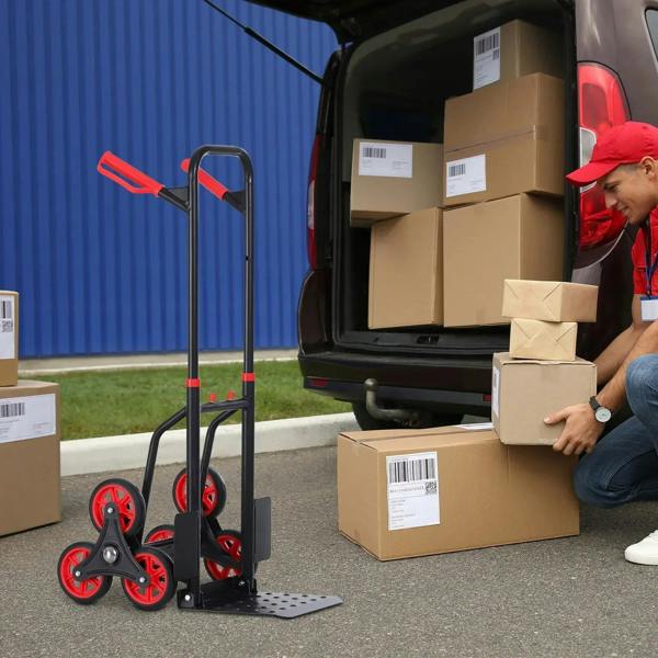 Red and black hand truck trolley next to a van with boxed cargo