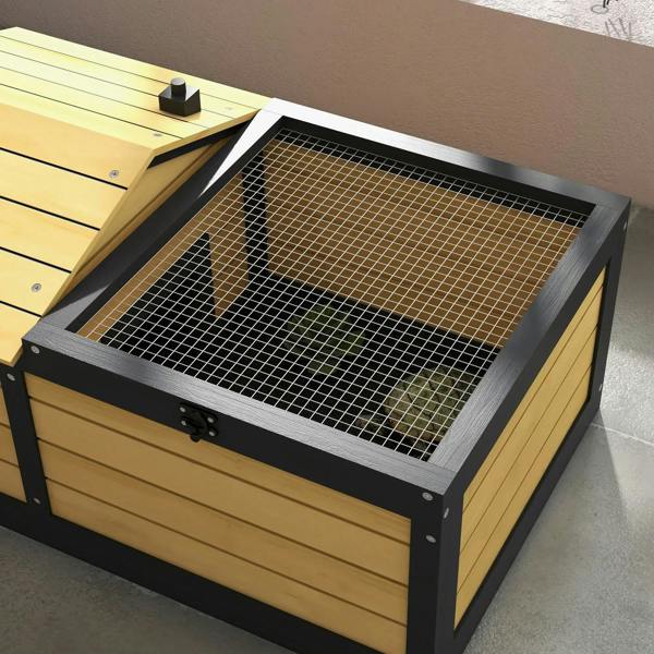 Close-up of yellow wooden reptile shelter top with black wire-mesh grid cover