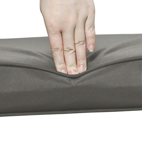 Dark gray cushion corner with hand adjusting the fabric seam and edge