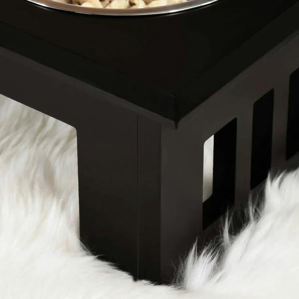 Brown raised dog feeder stand with vented side panels and stainless steel bowls