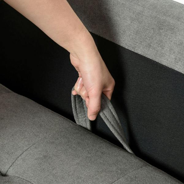 Grey fabric sofa storage flap being pulled by a hand