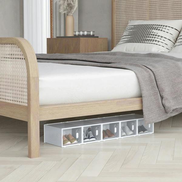 Clear plastic shoe organizer boxes under a bed with transparent front compartments