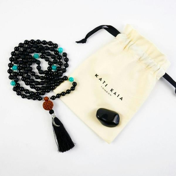 Kati Kaia Black Obsidian Crystal Necklace with turquoise accents and tassel in a drawstring pouch