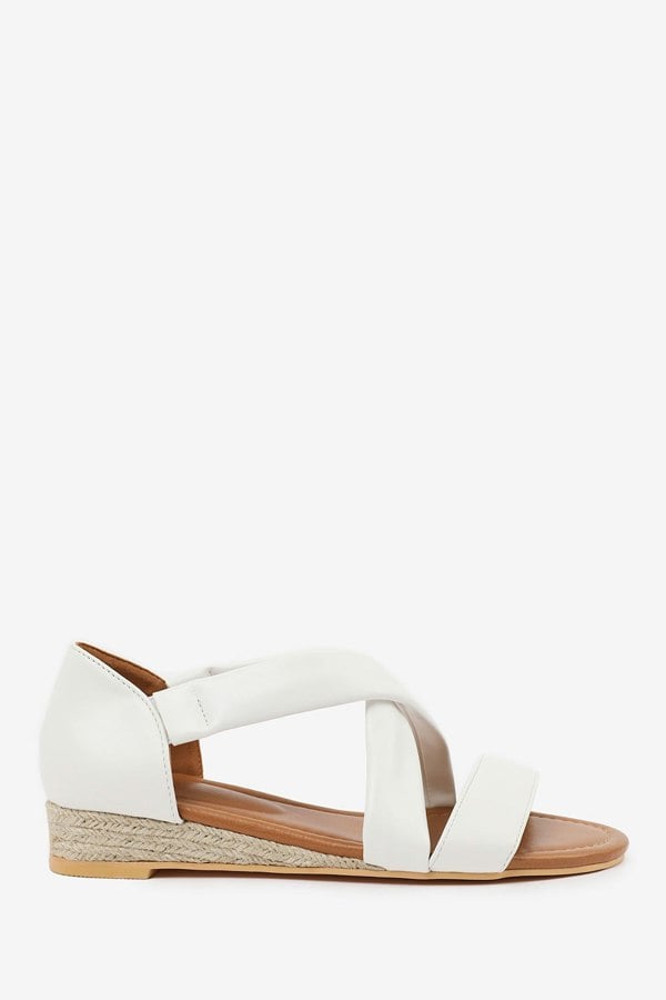 Where's That From Hummingbird Wide Fit Low Wedge Shoes With Cross Over Strap in White