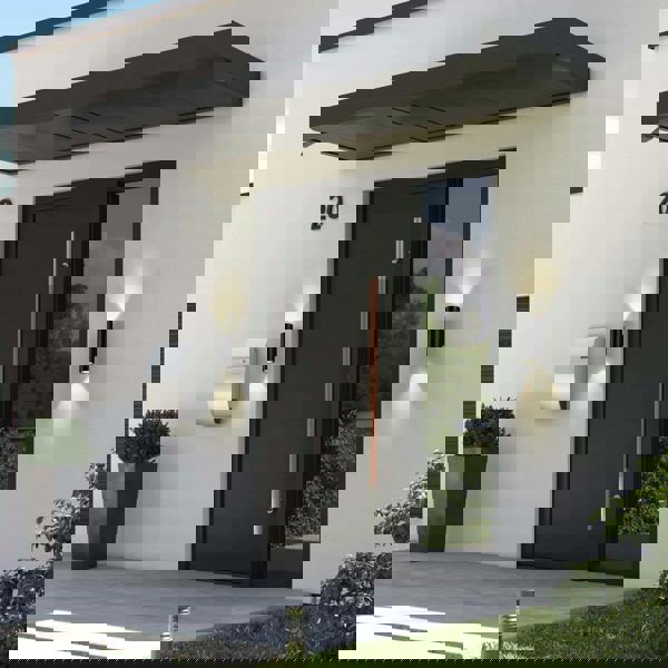 black outside up and down light mounted either side of the entrance door of a modern home 