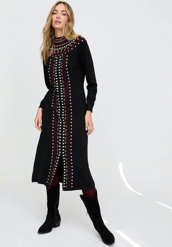 Woman wearing a long black dress with decorative elements on a white background