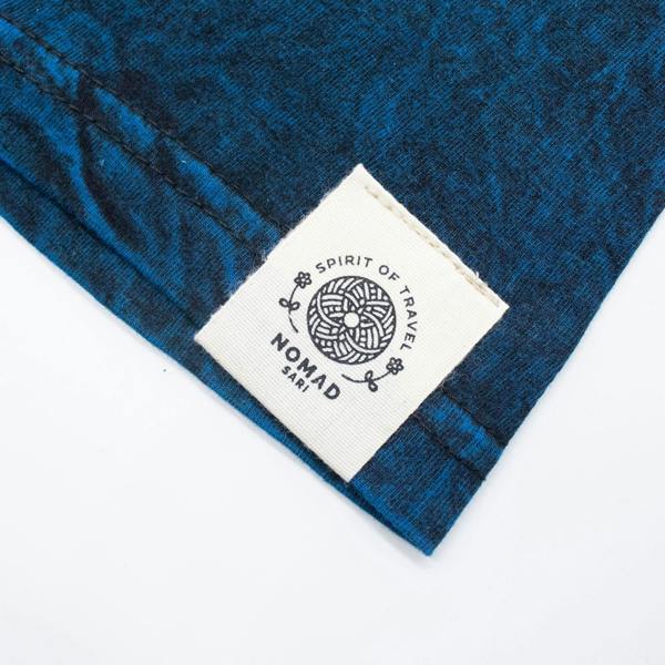 Blue t-shirt with stitched fabric label at side of sleeve