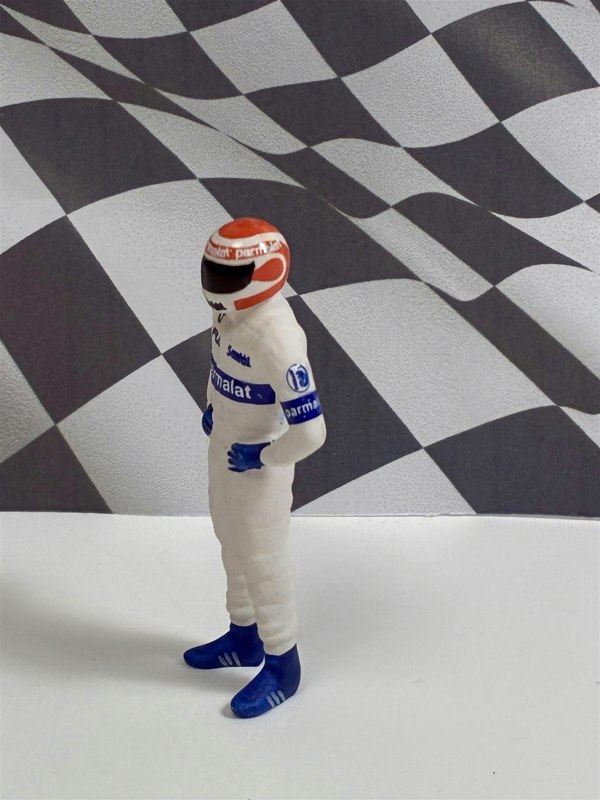 a toy figure of a race car driver