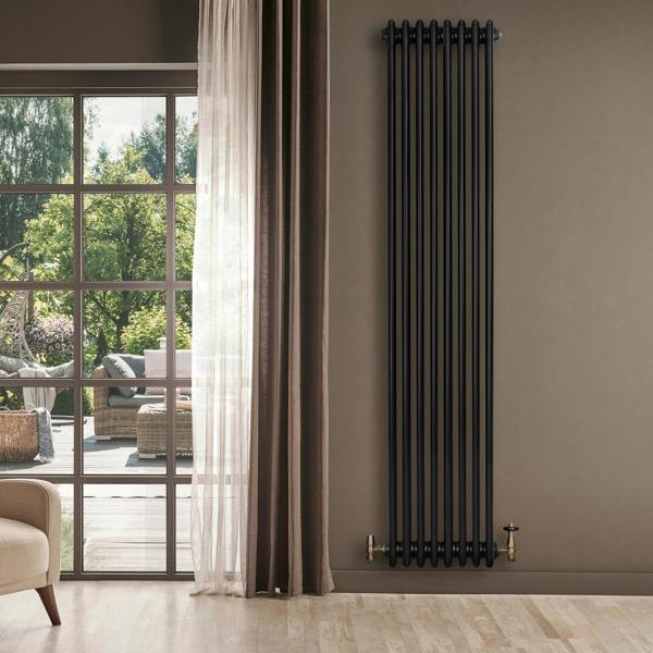 Traditional black 4 column radiator, 1800 x 380mm, mounted on a wall, with elegant brass valves, enhancing a modern living space