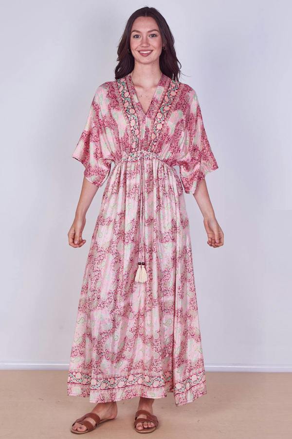 Woman wearing a pink floral dress against a white background
