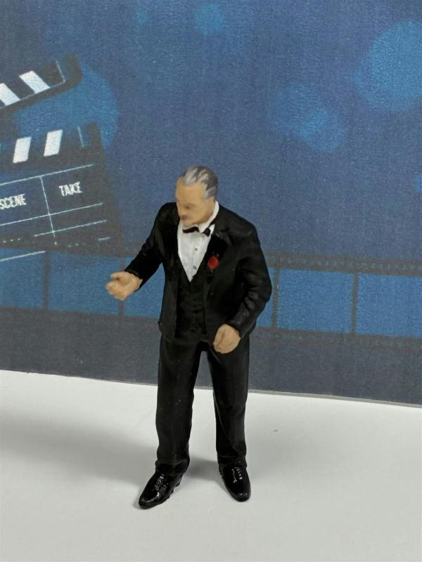 a toy figurine of a man in a tuxedo