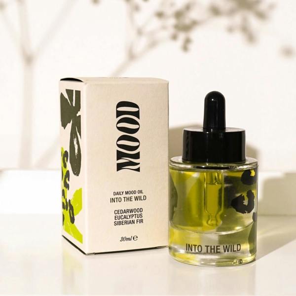 Into the Wild Daily Aromatherapy Mood Oil bottle with glass dropper next to green patterned box by Abode Home & Gifts