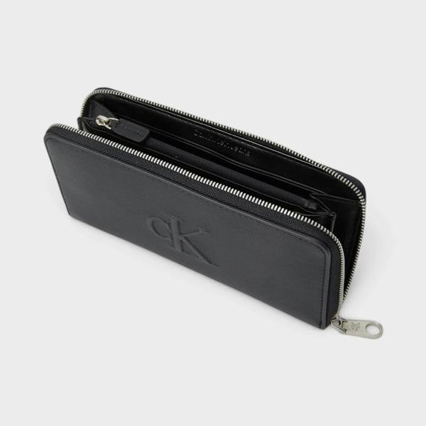 Supplied Fashion black Calvin Klein zip-around wallet with sculpted logo and silver hardware