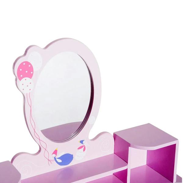 Oval pink-framed vanity mirror on a kids pink dressing table with decorative bird motif