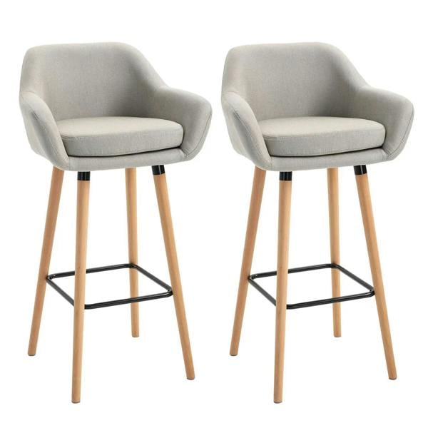 Set of 2 beige upholstered bar stools with curved seats, wood legs, and black metal footrests