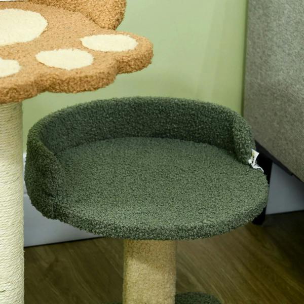 Close-up of dark green oval cat bed on a beige scratching post base