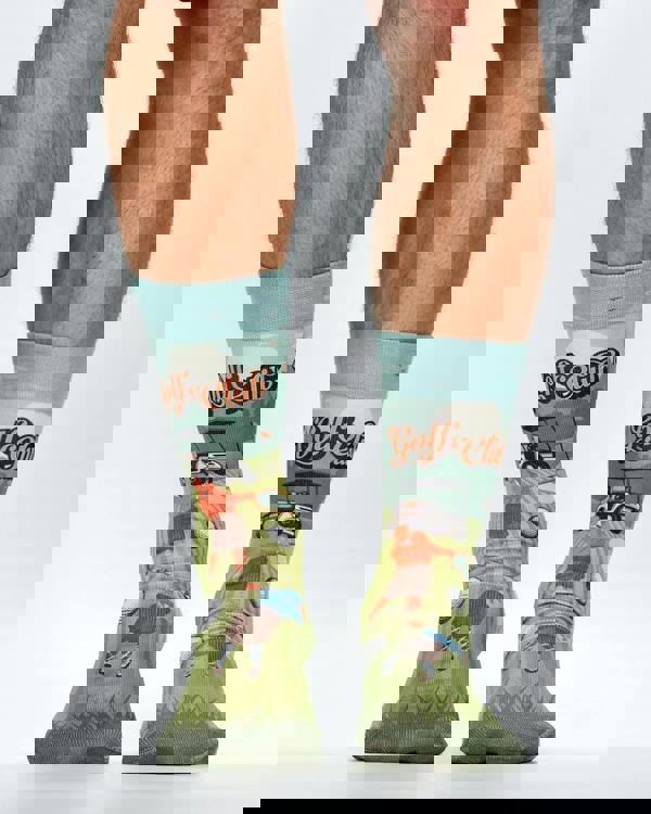 Golf-themed socks with cartoon raccoons playing golf on a white background