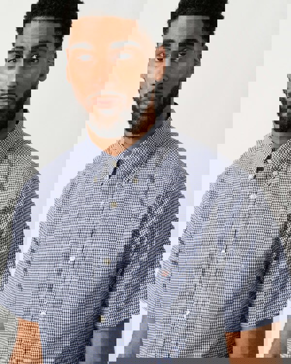 detail shot of a Model wearing a GANT Mens Regular Fit Classic Poplin Gingham Short Sleeve Shirt in Persian Blue