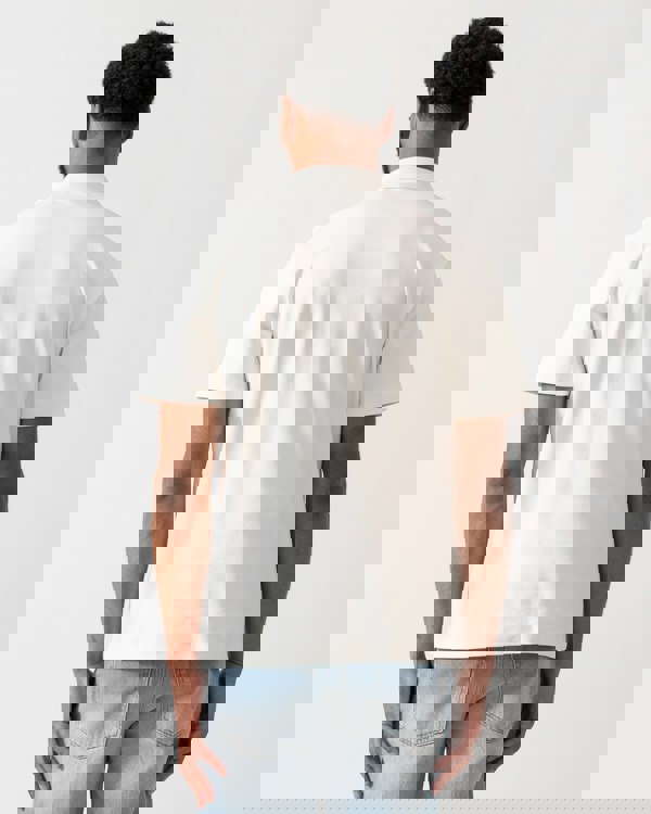 back of a model wearing a HUGO Deabono Mens Interlock Cotton Polo Shirt with Stacked Logo in Natural white