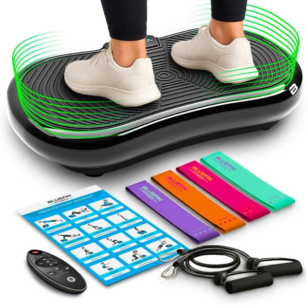 Vibration plate with two feet on it, resistance bands, remote, and workout guide nearby.