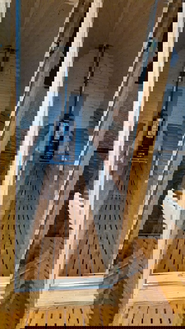 Barrel sauna interior with benches and stove