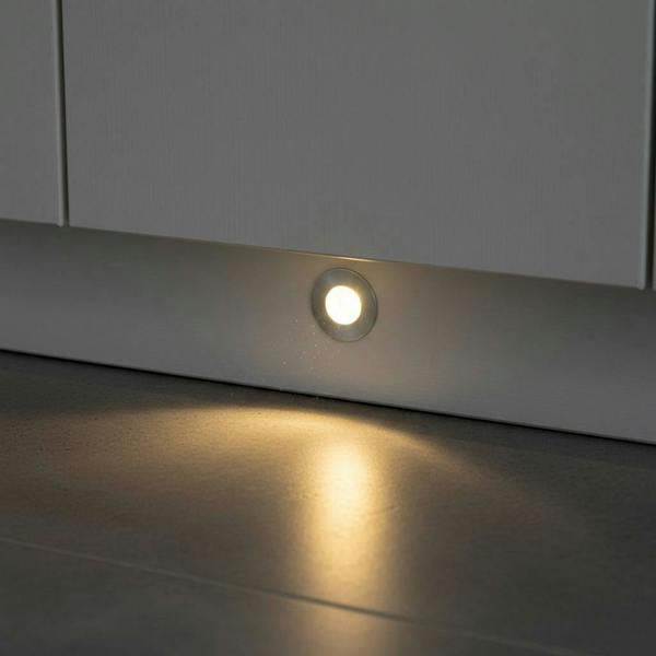 silver LED kickboard light shown recessed into a white low level kitchen plinth