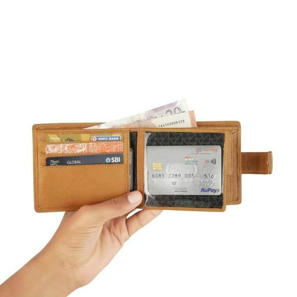 Hand holding a cognac wallet with cards and money on a white background