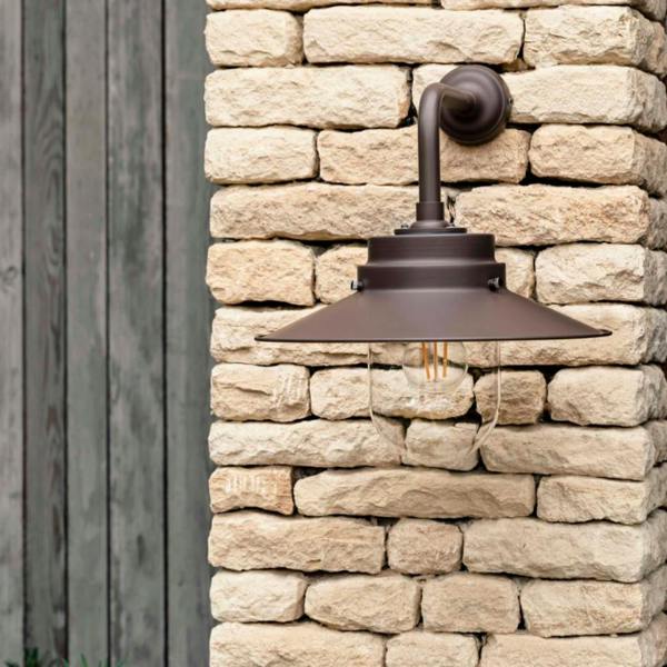 HMS Belfast inspired deck light in Coffee Bean steel mounted on a light stone wall, representing one of four available nautical-inspired colours.