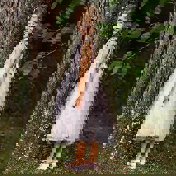 girl in a garden wearing Belle of The Ball lace and sequin dress