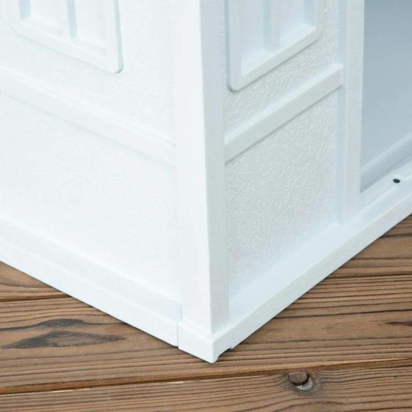 White plastic dog house base and side panel detail on wooden floor