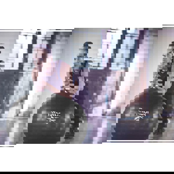 Woman performing a plank on Reebok 75cm Gym Ball - Black