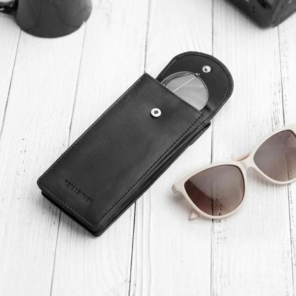 Flat lay of Black leather double glasses case with two pairs of glasses