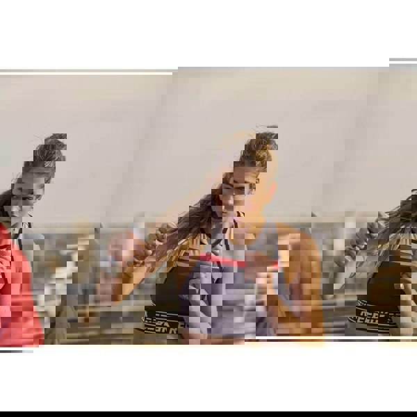 Woman exercising outside using Reebok 1kg Dumbbells