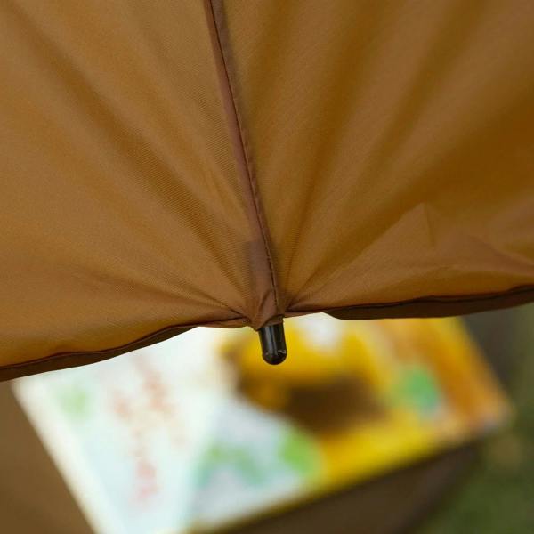 Brown sun umbrella fabric panel with metal canopy joint detail