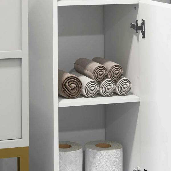 Open white bathroom cabinet shelf holding neatly folded towels