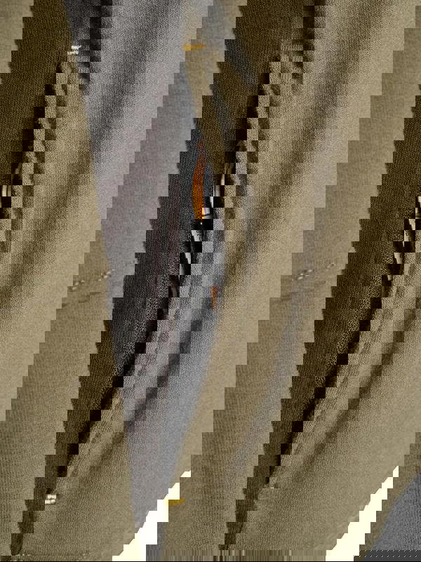 JCB Crew Trade Mens Work Pull Over Sweat Shirt, close-up view of the zippered pocket showing a black zipper and brown zipper pull on an olive green sweatshirt.