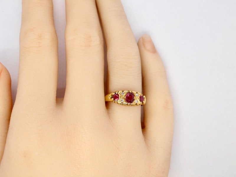 A vintage style ruby and diamond ring finger view