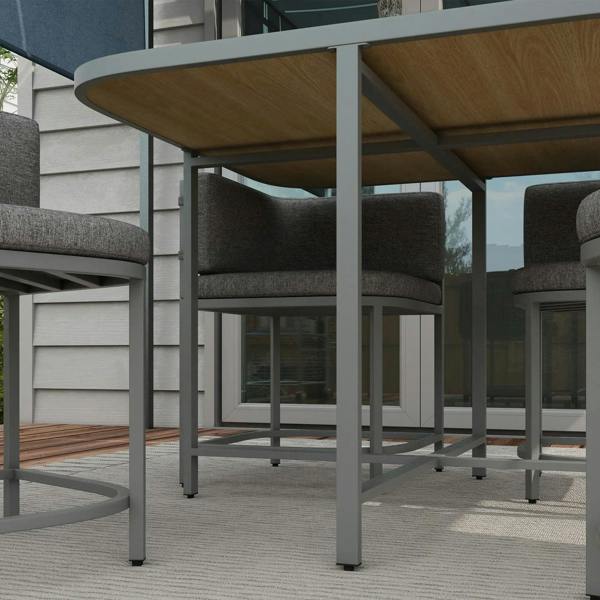 Grey rattan cube dining chairs with thick cushions beneath the table