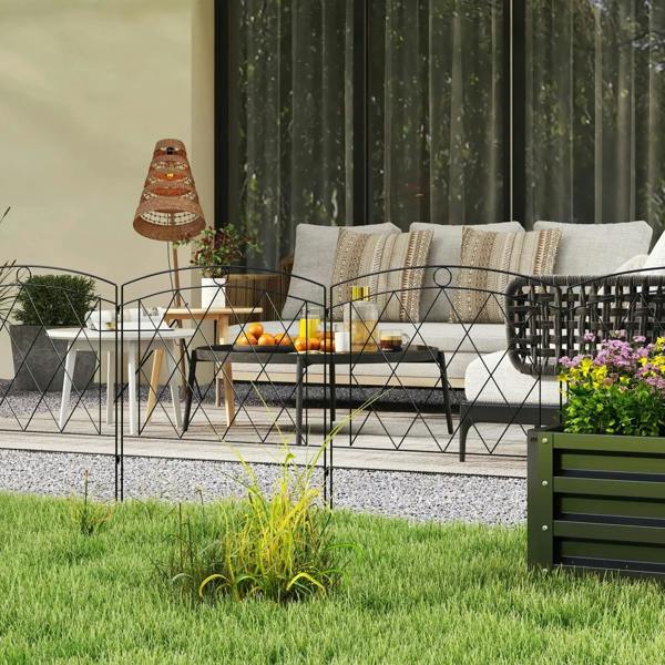 Black metal decorative fence panels with diamond lattice, installed along a patio garden