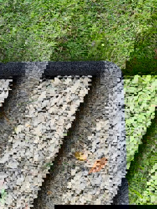 Black Flexiborder in a garden edging the lawn and stones