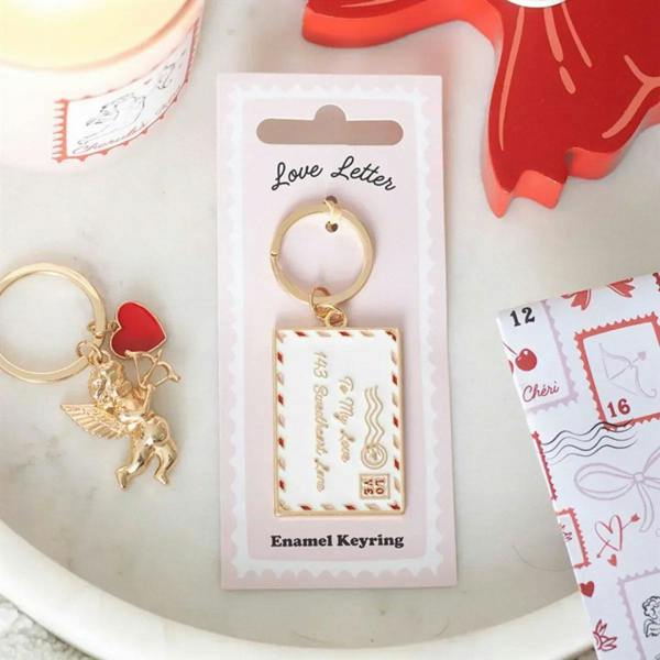 Enamel keyring on pink card: gold ring, heart charm, square love-letter enamel