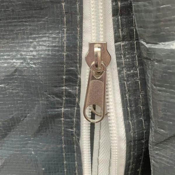 Dark grey shed door zipper with metal pull and white zipper track