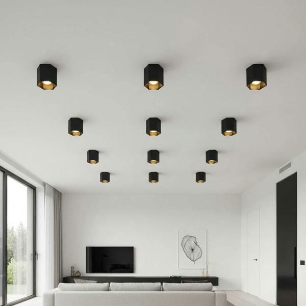 black flush ceiling lamp fixture mounted in a group on a white ceiling in a home