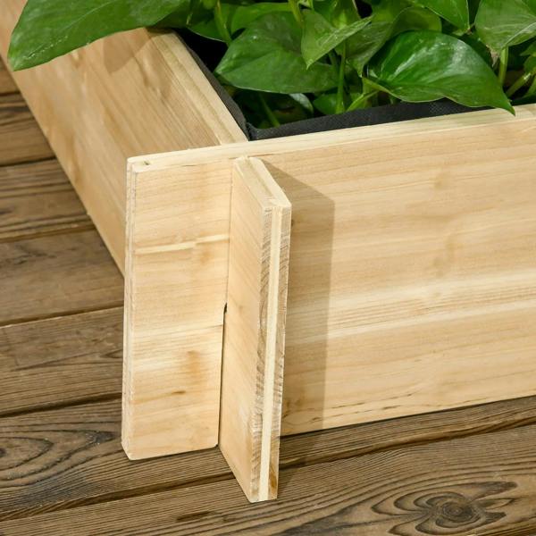 Close-up of natural wood planter corner post and side wall with plants inside bed