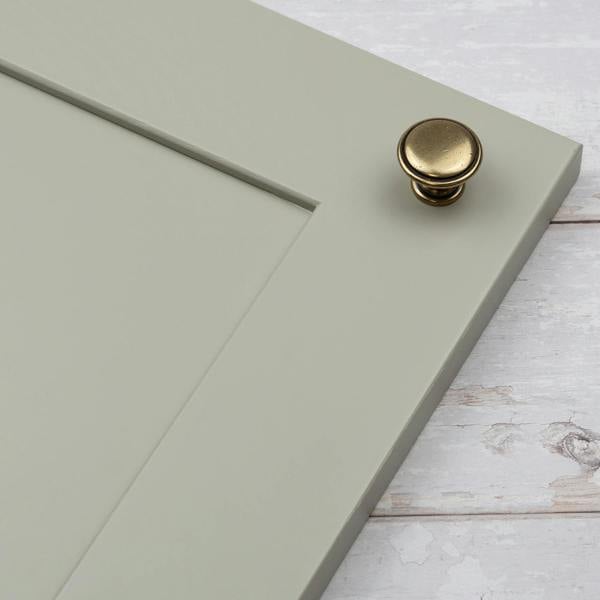 An antique brass round circular cabinet knob 