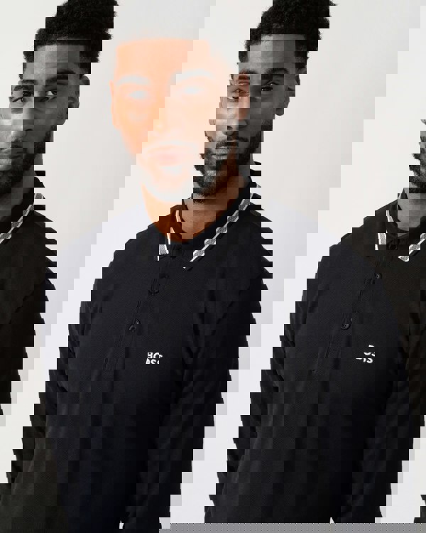 detail shot of a Model wearing a BOSS Green Plisy Mens Long Sleeve Polo Shirt in Dark Blue