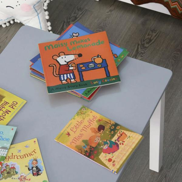 Kids table with grey smooth tabletop holding several storybooks