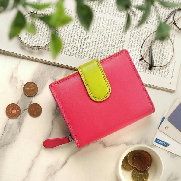 Pink leather purse placed with daily essentials for a lifestyle view